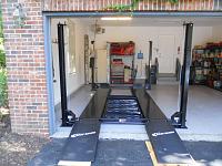 To leave space at rear of garage for refrigeraor and tools, locaed the lift near the door. Therefore ramps need to stick outside. BTW replaced heavy steel ramps with ligthweight RaceRamps. BIG...