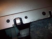 Back of the new trim..you can see the underneath of one of the stock plastic rivets after being ground off in the middle, right is the new replacement screw.  (left screw is an original hex screw)