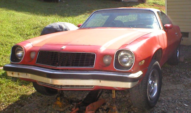 on stands after motor swap. I aint sure how but it seems that during this all the hood has become really faded. maybe the fenders are just covered with oil and grease and appear shiny haha