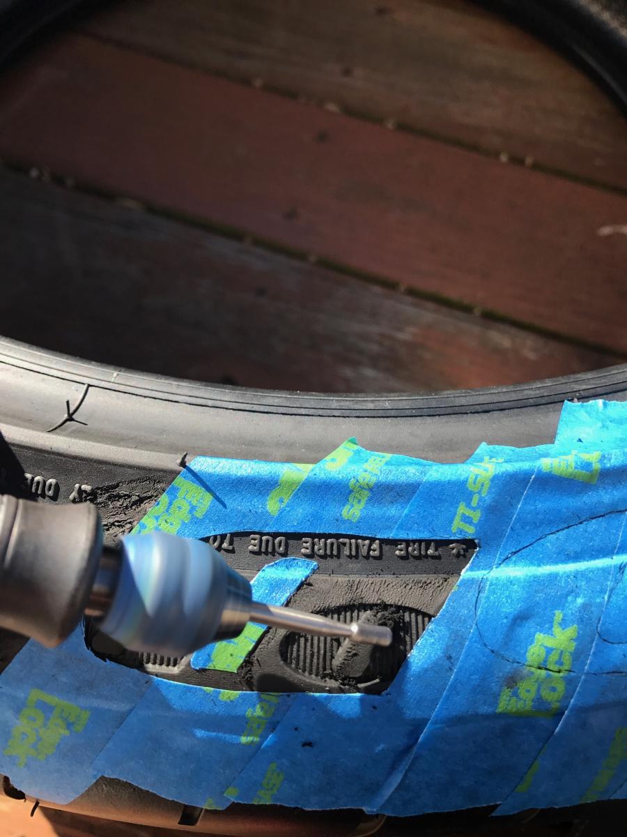 Carefully grinding for lamination of Tread-Wear custom tire letter installation.