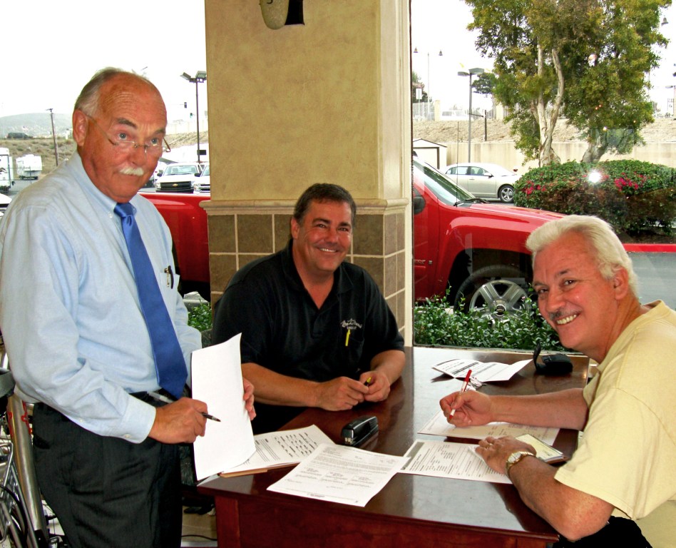 That's my Dad signing the check to conceive me! I know he is going to care about me because my big sister was his first baby many years ago. My big sister and I look a lot alike but we are so much different. Mom was taking the photo. The other nice gentlemen are (L-R) Chris Caumartin who drafted and submitted the conceptions papers (GM Workbench) and Dave Perry, the public relations manager and salesman. They are all happy because they know my birth is going to help the economy and make my soon to be parents very happy. Look my Dad has a "Permagrin" because he already knows what he is in for. He LOVED my big sister dearly and has missed her ever since she left home in 1978.